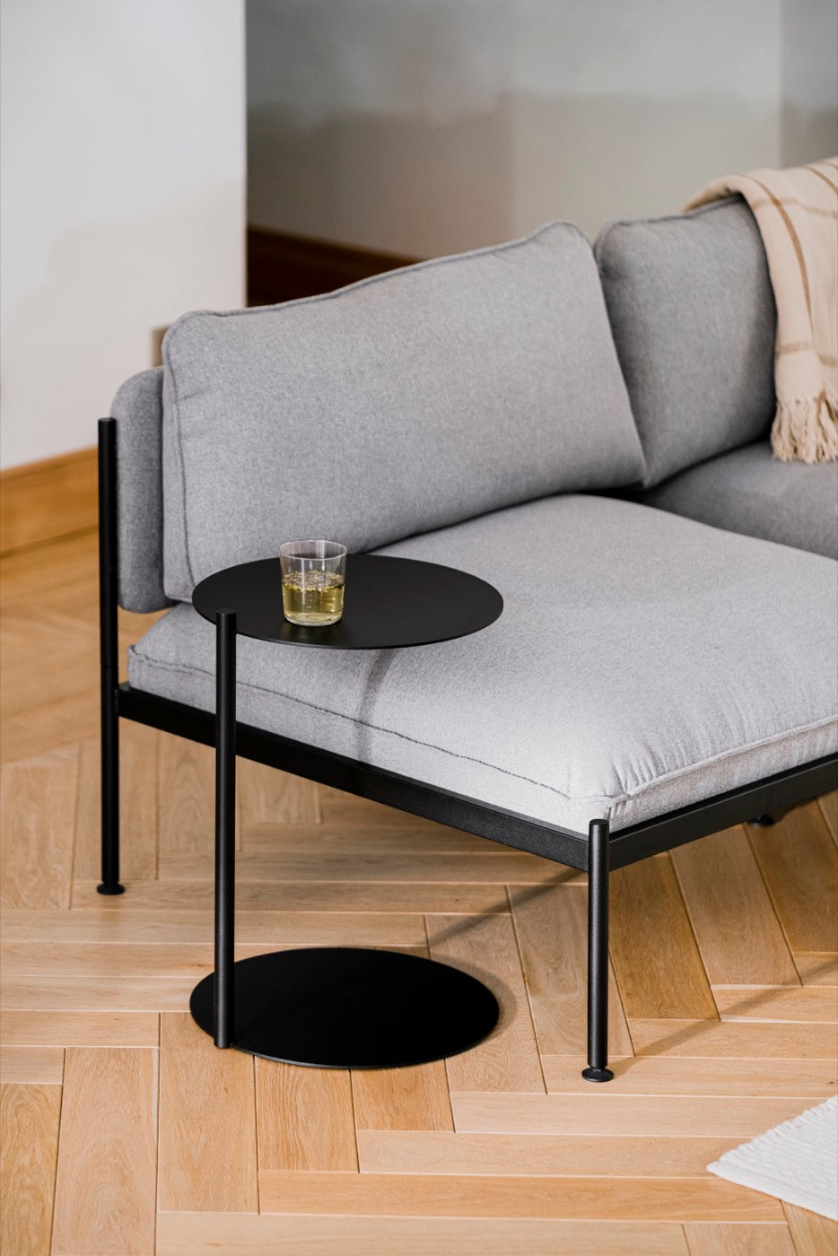 black indoor living-room side-tables light-grey sofas 