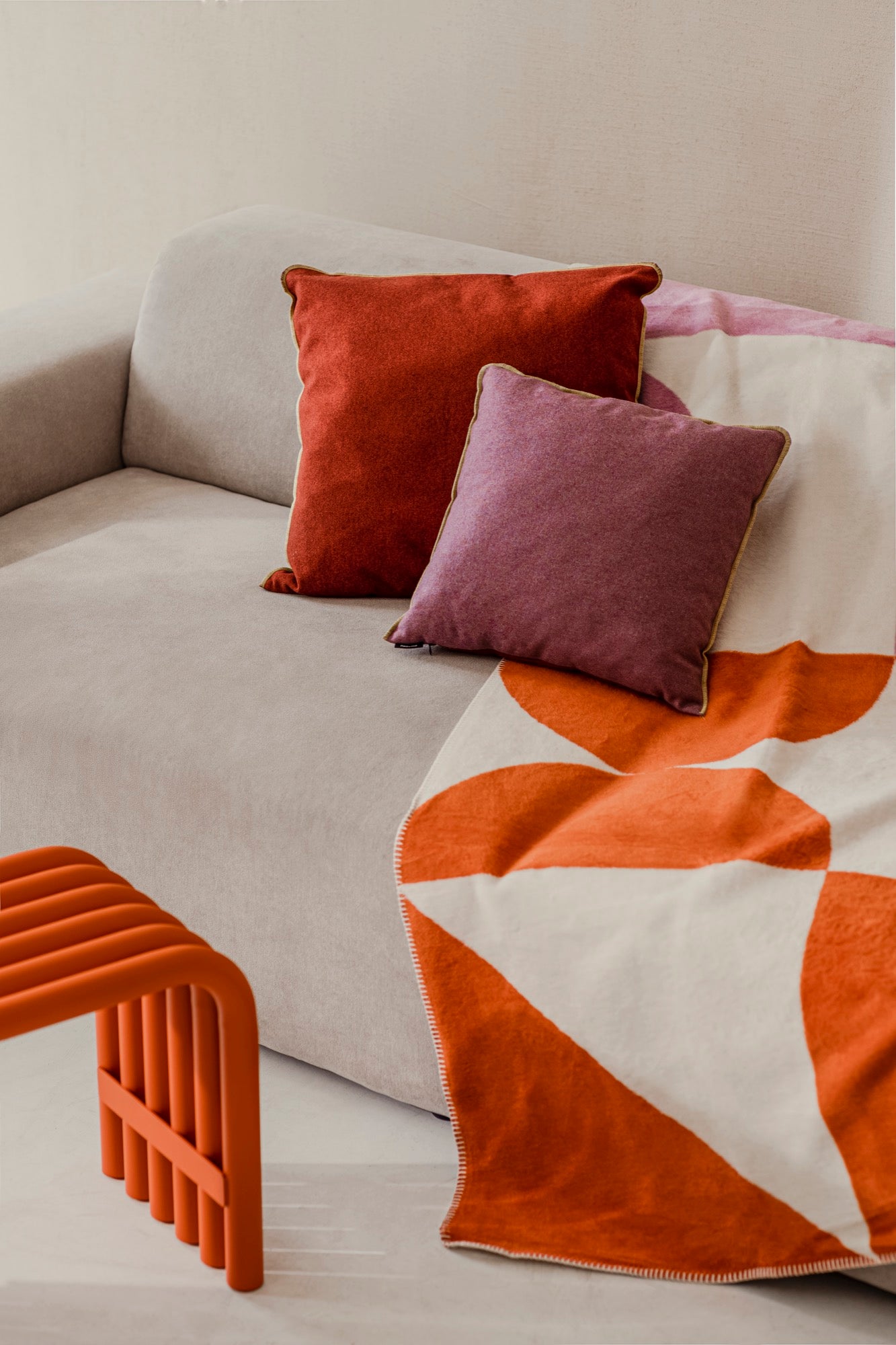 indoor living-room red throws beige cushions orange pink violet 