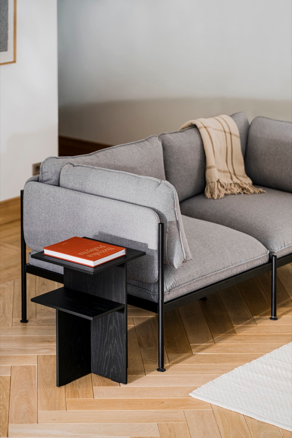 indoor light-grey living-room side-tables black sofas 