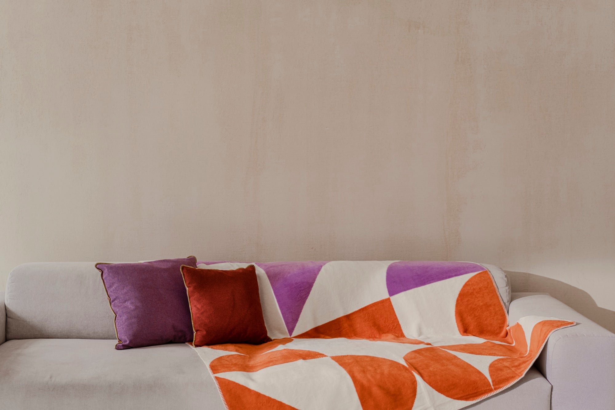 gift-guide indoor living-room pink throws cushions orange red terracotta violet 